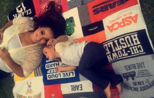 Amanda & Mira lay on a quilt made of Joe's shirts
